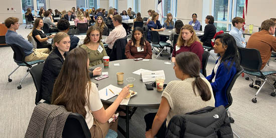 High school juniors in round-table discussions led by Rotary volunteers at RYLA conference.